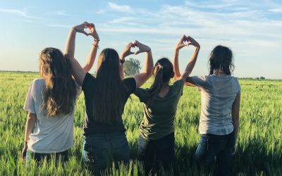 women forming heart gestures during daytime